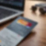 A close-up view of a credit card on a desk with a laptop and financial documents.