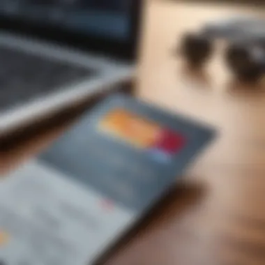 A close-up view of a credit card on a desk with a laptop and financial documents.