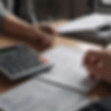 A person calculating finances with a calculator and notepad