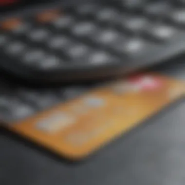 A close-up view of a credit card with a calculator and financial documents in the background.