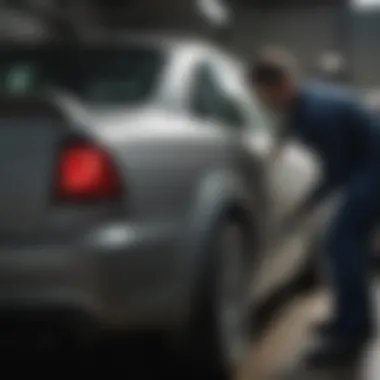 A professional technician at work painting a car fender in a workshop